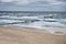 Seaside of Baltic Sea in Poland. Sto rmy sea, with waves hiting wooden poles. Bird view, aerial view from high up.