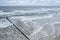 Seaside of Baltic Sea in Poland. Stormy sea, with waves hiting wooden poles. Bird view, aerial view from high up.