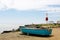 Seaside, boat and lighthouse in Portland, Dorset, UK