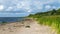 Seaside landscape from Estonia, sea grasses and rocks in shallow sea water, Kabli bird center, Parnu Bay, Estonia