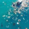 Seaside pollution depicted through floating garbage, highlighting environmental concerns