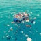Seaside pollution depicted through floating garbage, highlighting environmental concerns