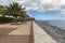 Seaside promenade with palms and pebbles beach at Madeira Island