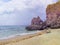 Seaside scene with mountain. Aqua blue sea water and yellow sand beach.