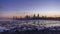 Seaside skyline of Kuwait city from night to day timelapse