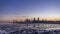 Seaside skyline of Kuwait city from night to day timelapse
