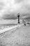 Seaside with street lamps in perspective black and white. Adriatic seascape monochrome. Italian coastline.