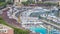 Seaside swimming pool in Monaco timelapse, with people and buildings in the background.