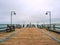 Seaside Telescope . Autumn misty morning on wooden pier