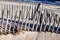 Seaside weathered wooden fences on sandy beach