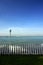 Seaside white wooden picket fence and lamp post