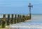 Seaside with wooden groyne going into sea