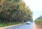 Season rubber trees change  leaves on outskirts road with traffic background