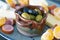 Seasonal appetizer platter with olives, cheese, meat and oranges