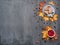 Seasonal autumn background. Frame of colorful maple leaves and a nutmeg, cake, raspberries and cinnamon over grey