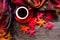 Seasonal autumn leaves.  Cup coffee hot steaming  warm scarf on wooden table background in morning relax sunny day.