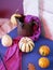 Seasonal decorative still life of pumpkins, purple fabric, black plasticine spider
