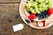 seasonal fresh fruits in a bowl on wooden table, sign with copyspace