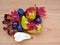 Seasonal fruits, pears, plums and fall leaves over wooden table