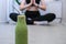 Seasonal Matcha green vegan smoothie with chia seeds and mint smoothie drink detox. Woman doing yoga on background Clean