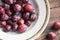 Seasonal plums on a wooden table