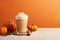Seasonal pumpkin spice latte on orange background