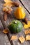 Seasonal pumpkin on a table with autumn leaves, closeup