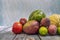 Seasonal summer fruit on a wooden table. African mango, limes, gaul melon, watermelon