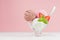 Seasonal sweet dairy dessert - ice cream scoops different flavor with spoon, strawberry slices, mint in elegant bowl in modern.