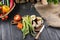 Seasonal vegetables and halved apple on wooden table top background