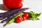 Seasonal vegetables - purple bean pods, cherry tomatoes, green Basil leaves, pea pods and red bell peppers. white background