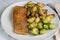 seasoned baked salmon with potato wedges and roasted brussel sprouts