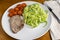 seasoned pork chop with zucchini noodle and tomatoes