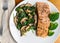 seasoned salmon with a side of sauteed spinach and mushrooms