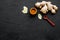 Seasoning. Ground ginger in small bowl near sliced ginger root on black background top view copy space