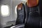 A seat on the plane. Empty cabin of the plane. Soft seats for passengers, portholes. Inside a passenger plane