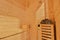 Seat in sauna room. Empty wooden steam room with stone heater. Sauna room for good health. Sauna room with traditional sauna acces