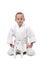 Seated boy in judo kimono,