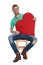 Seated cool man holding a big red heart in hands