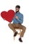 Seated curious man pointing his finger to a red heart