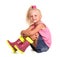 Seated cute little blond girl in blouse, skirt and rubber boots