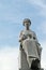 Seated female figure cemetery statue with mask