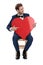 Seated gentleman pointing finger to red heart while looking away