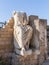 Seated statue with broken arms and head made of white marble in Caesarea Fortress on the Mediterranean coast near Caesarea city in