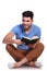 Seated young casual man reading a book and smiles