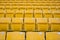 Seating rows in a stadium with weathered chairs