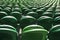 Seating rows in a stadium with weathered chairs