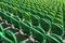 Seating rows in a stadium with weathered chairs