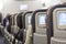 Seating space with multimedia screens economy class airplane cabin