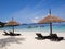 Seats with sun shelter on white sand beach sea view background, Travel plans after retirement of business people